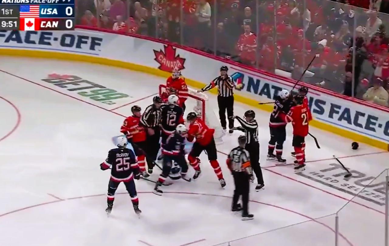 Ice hockey players fight in front of a goal
