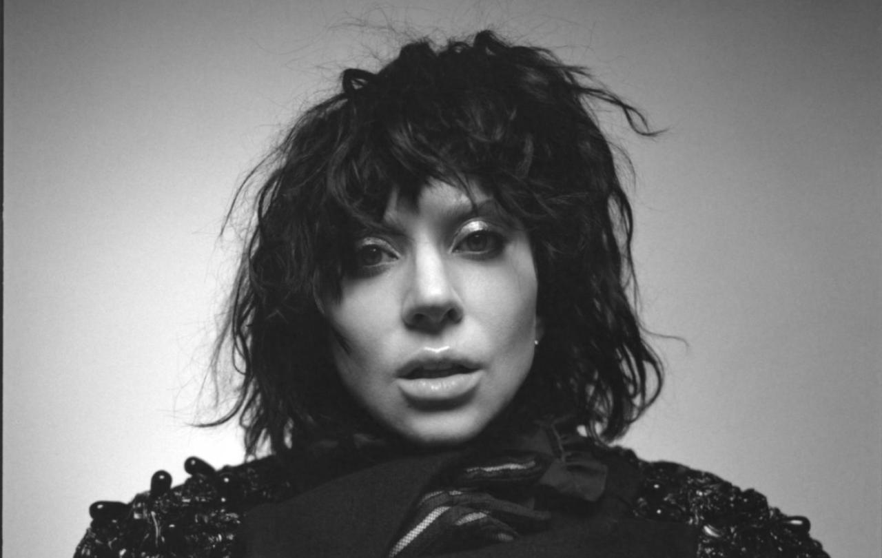 A black and white photo of a woman about to open her mouth to sing.