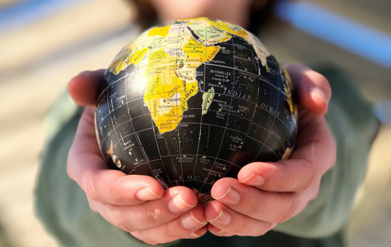 A small globe held in the hands.