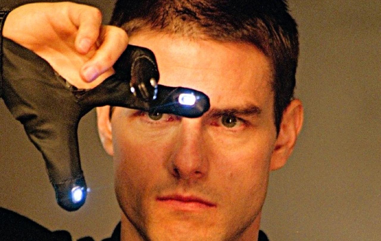 Tom Cruise gestures with his fingers in an e-glove in front of his face