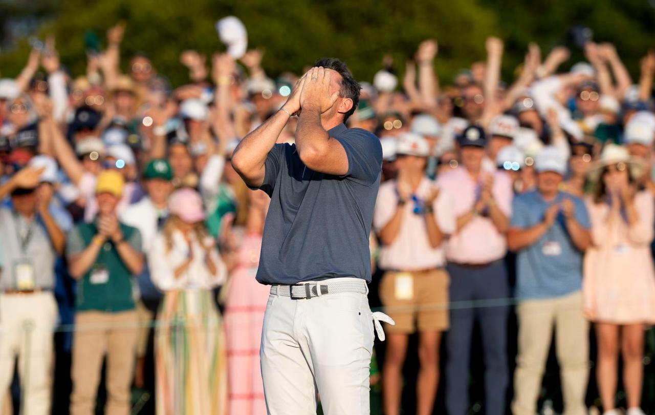 A golf clutches his face after winning a competition