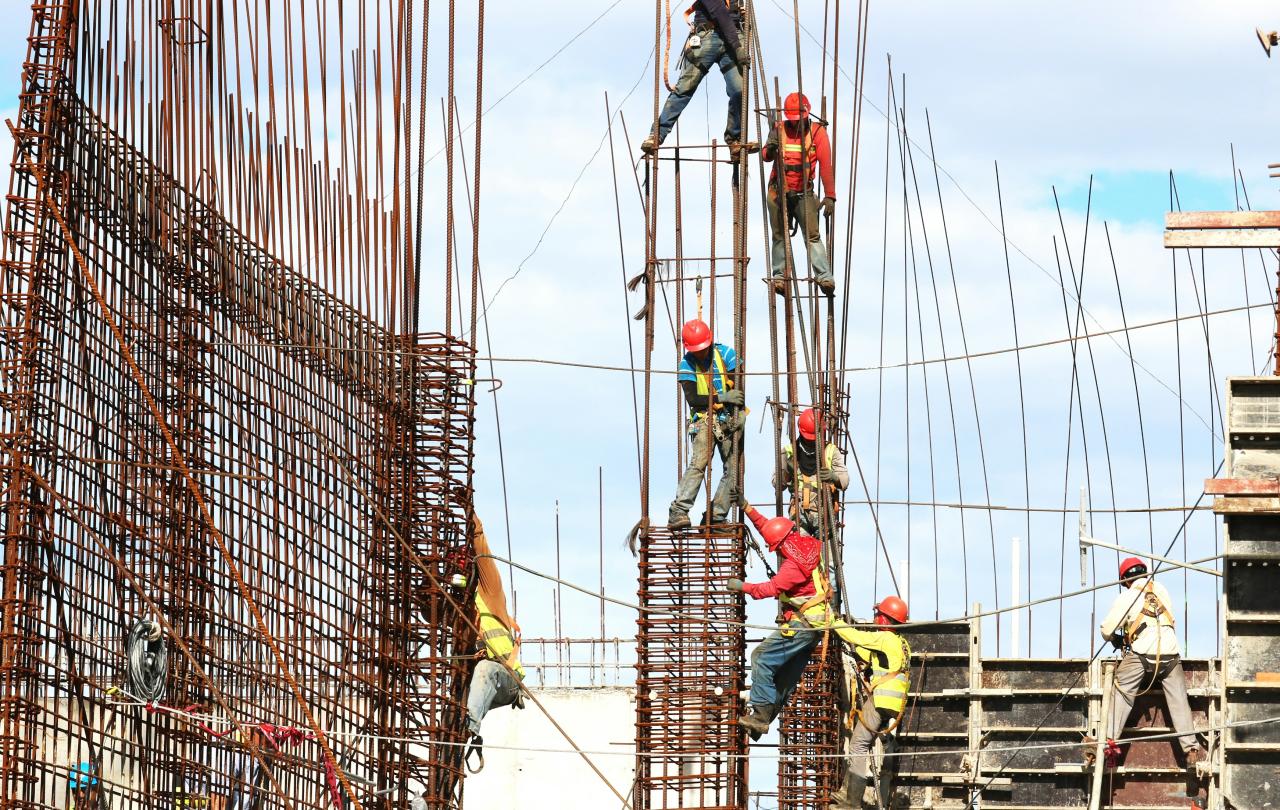 Construction worker climb a steel framework.