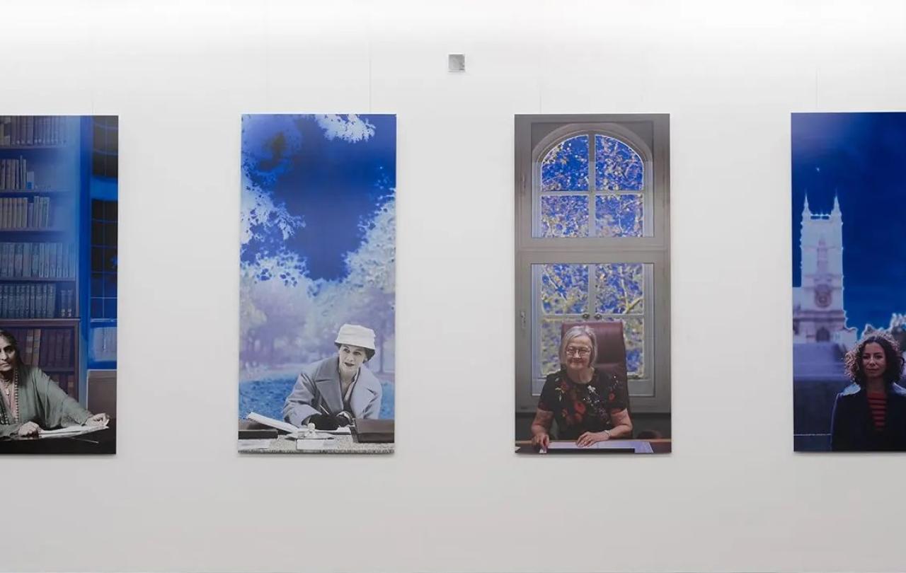 A paiting shows four panels featuring women lawyers over a century