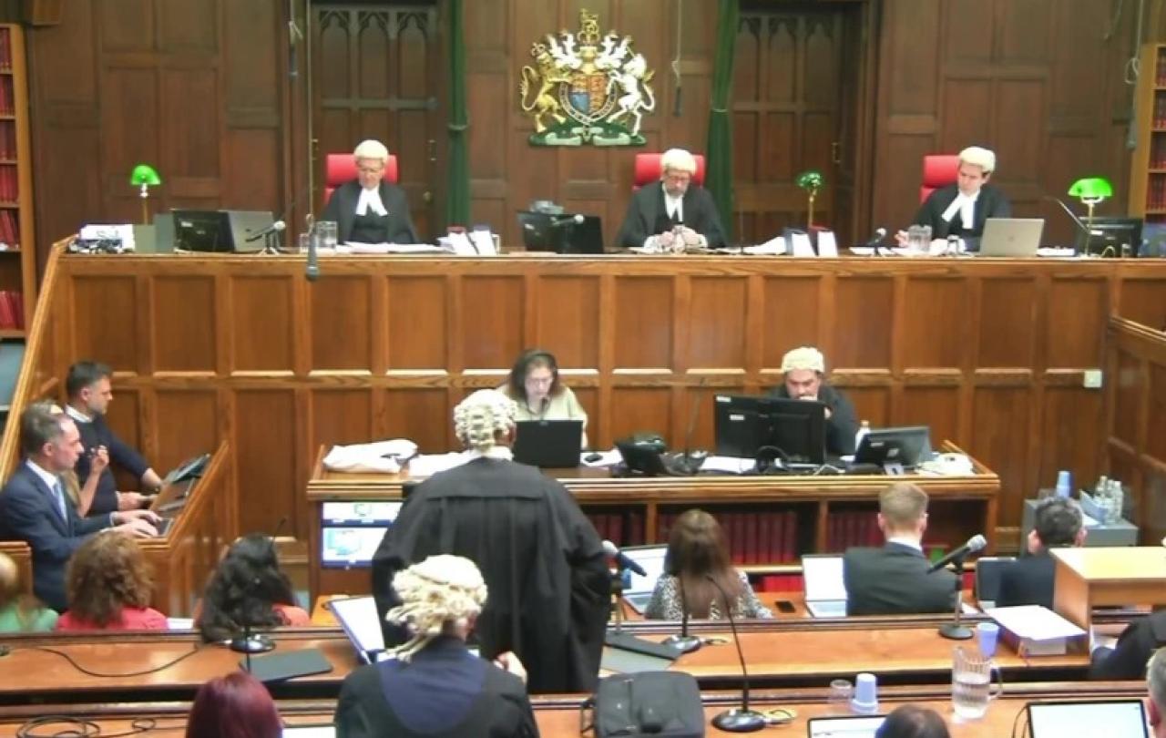 A court sits, with judges raised above the others.