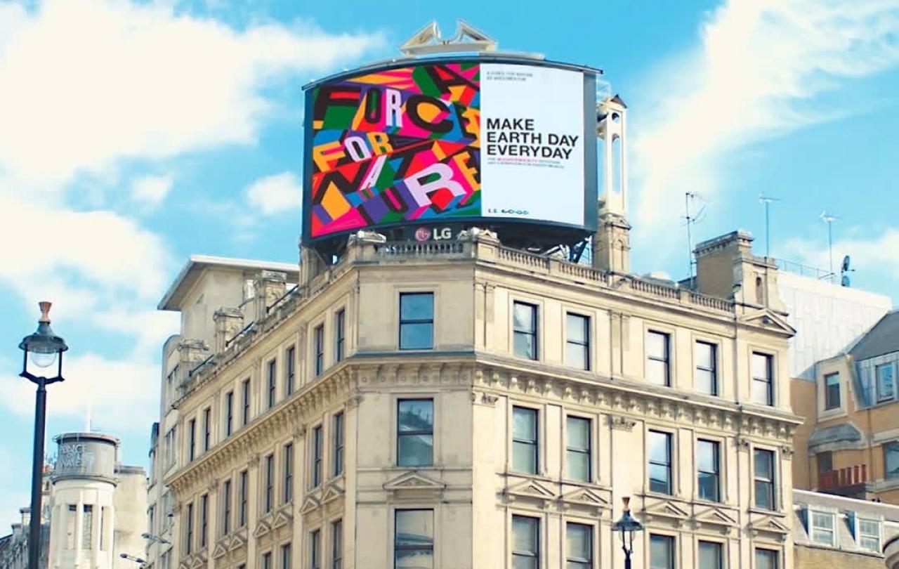 A digital billboard on top of a London building reads: Make Earth Day Everyday.