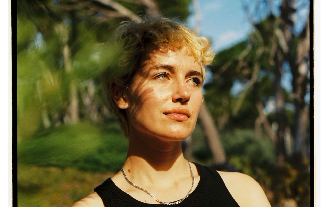 A woman stares away from the camera