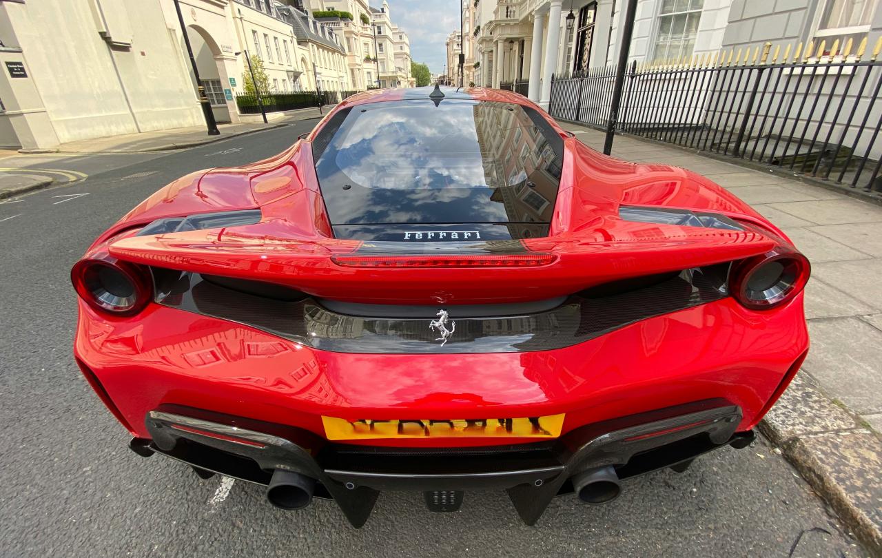 A red Ferrari parked on a posh London Street