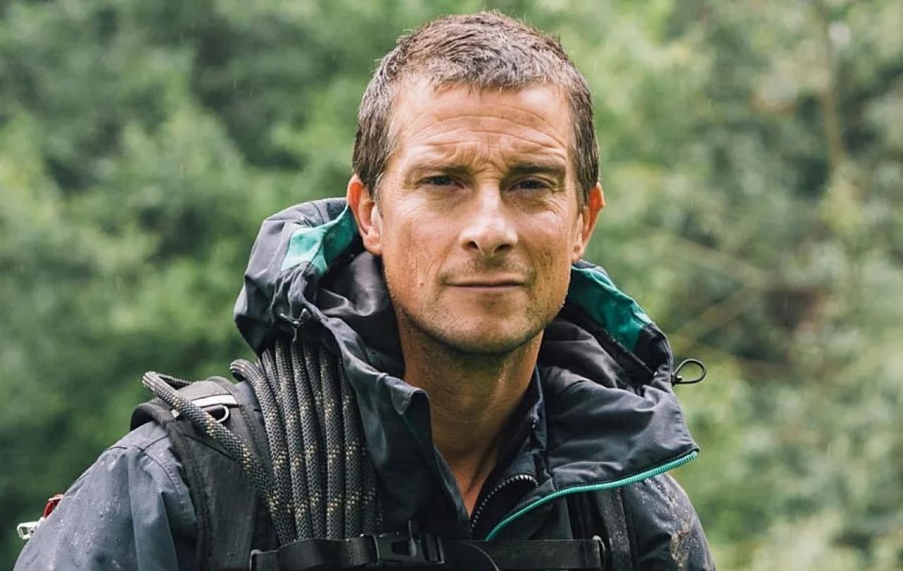 A wet-looking Bear Grylls looks at the camera.
