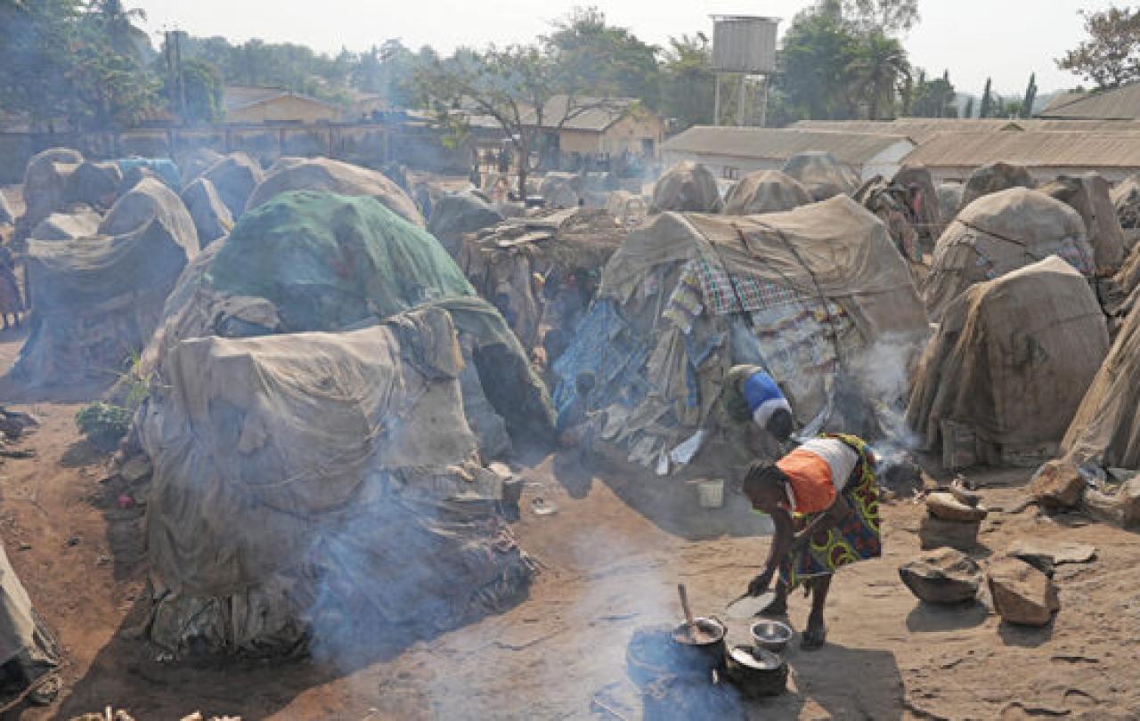 Small huts in a crowded refugee camp.