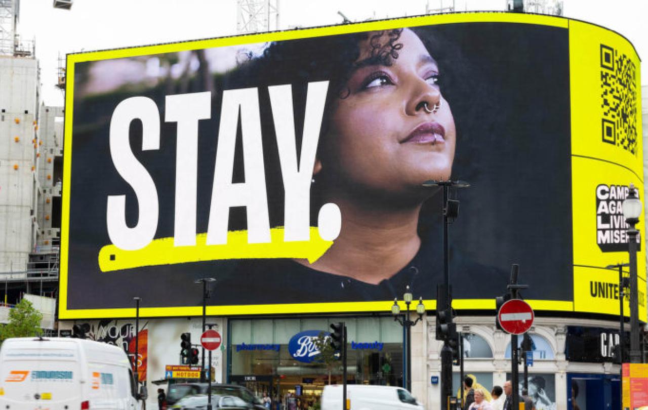 A digital billboard reads: STAY