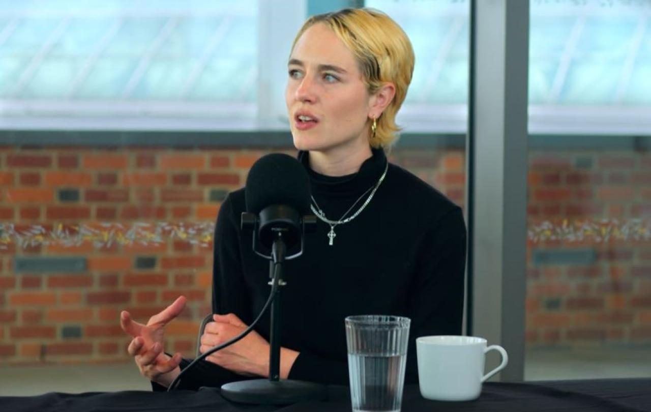 A podcast guest gestures with her hand while talking