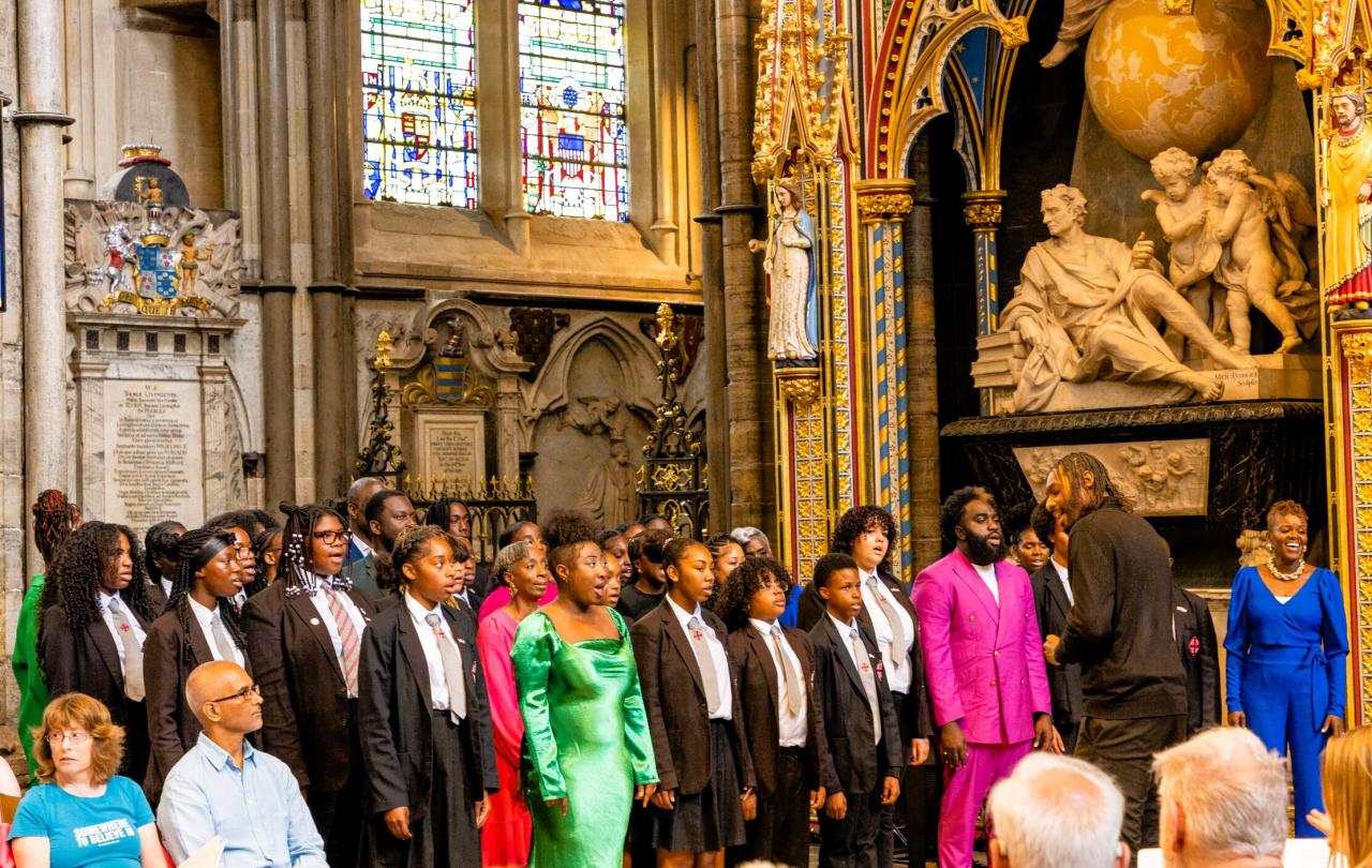 A school choir sings in an ornate abbey setting