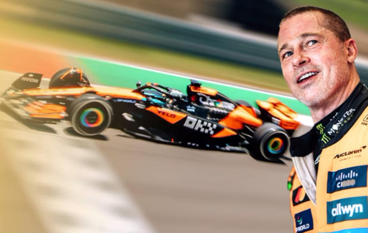 Brad Pitt dressed as a racing driver stands with a car in the background