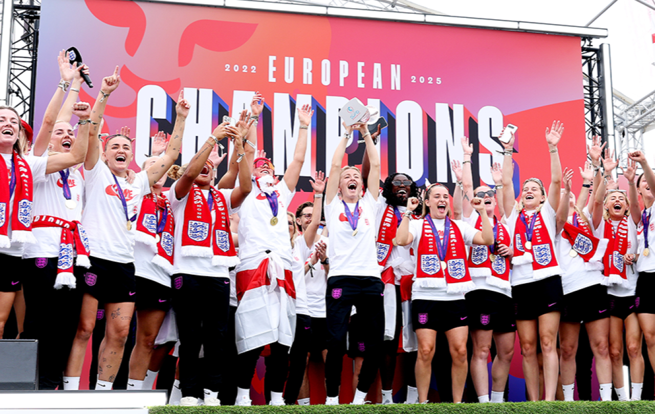 A victorious women's football team celeberate.