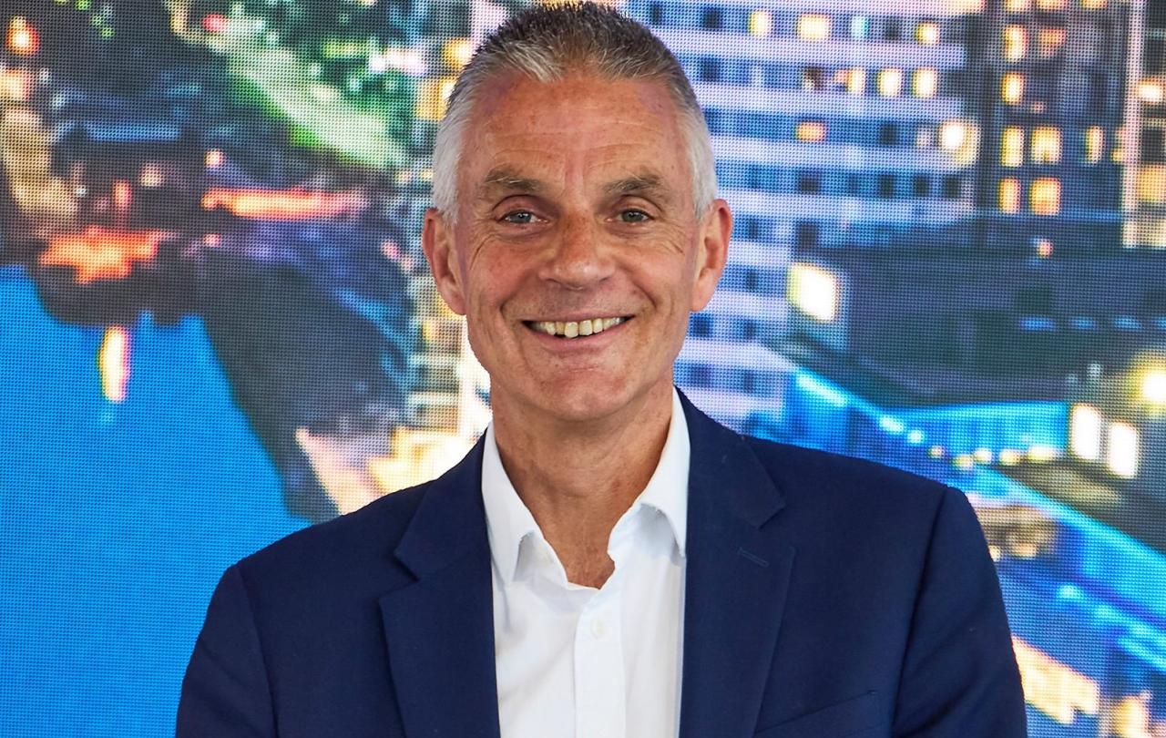 Tim Davie in a blue suite smiles