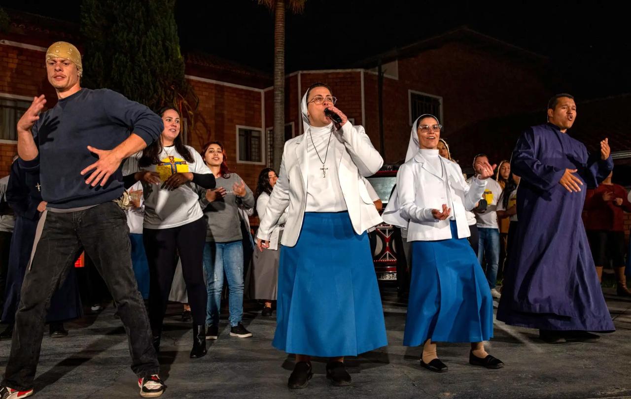 Two nuns with a band rap on stage
