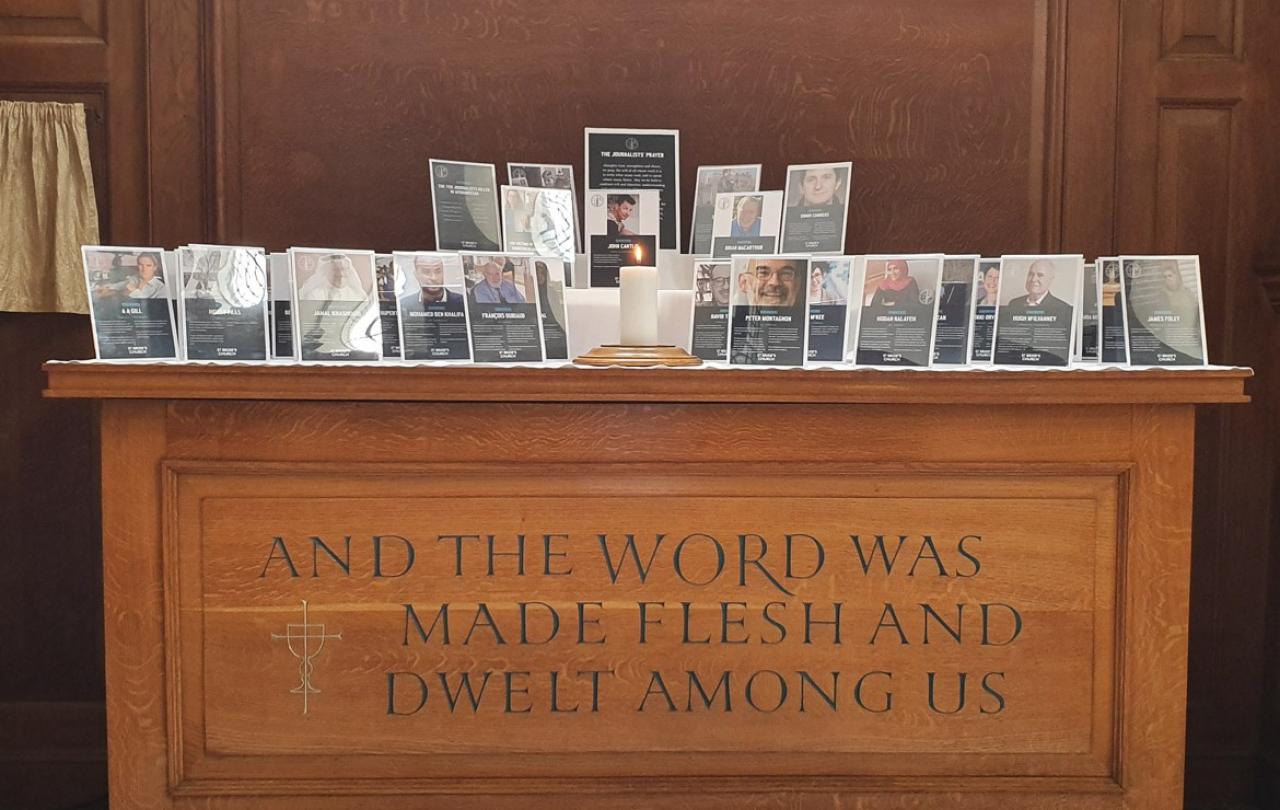 A church altar holds commemorative frames of killed journalists