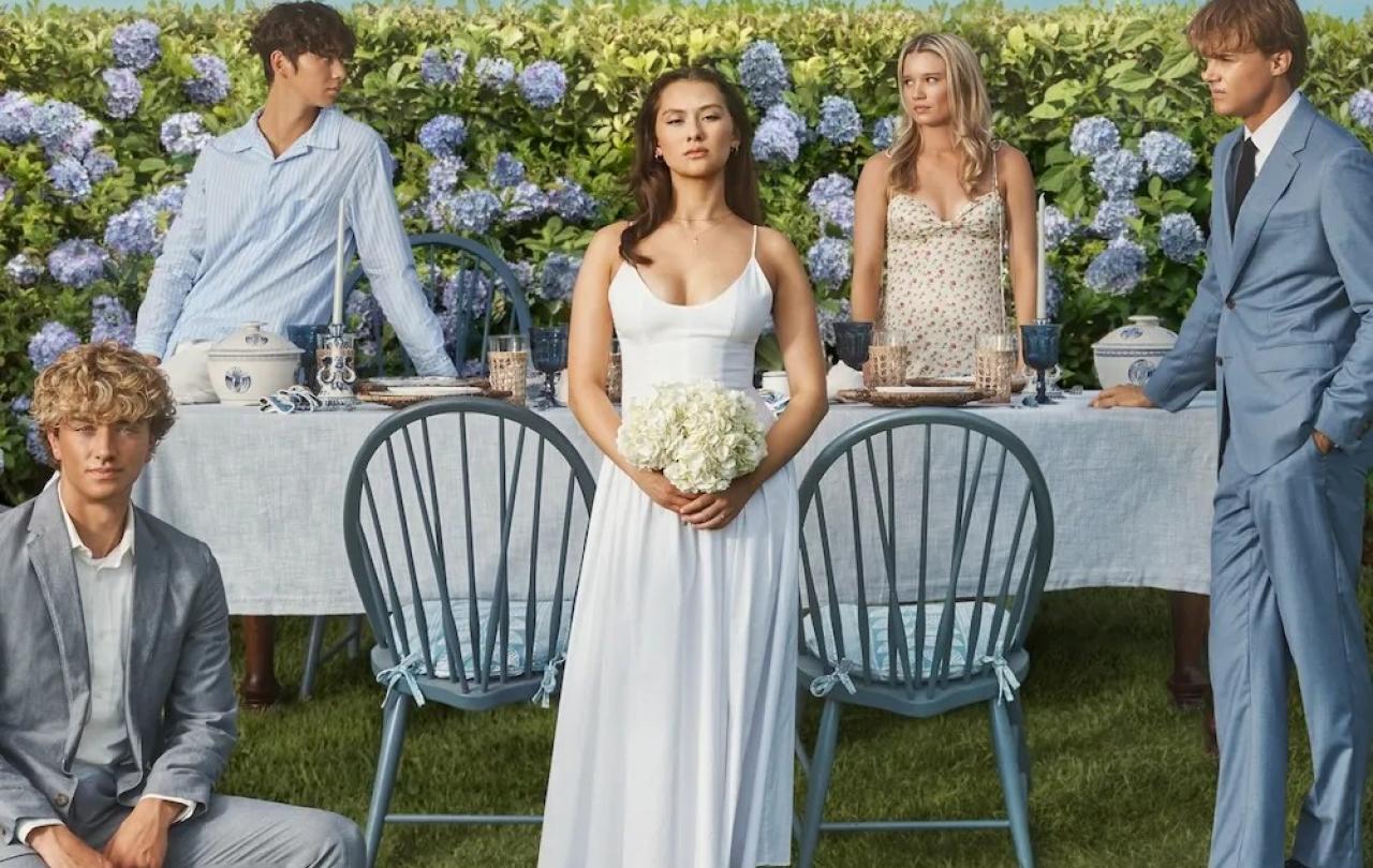 The cast of The Summer I Turned Pretty pose on a wedding set.