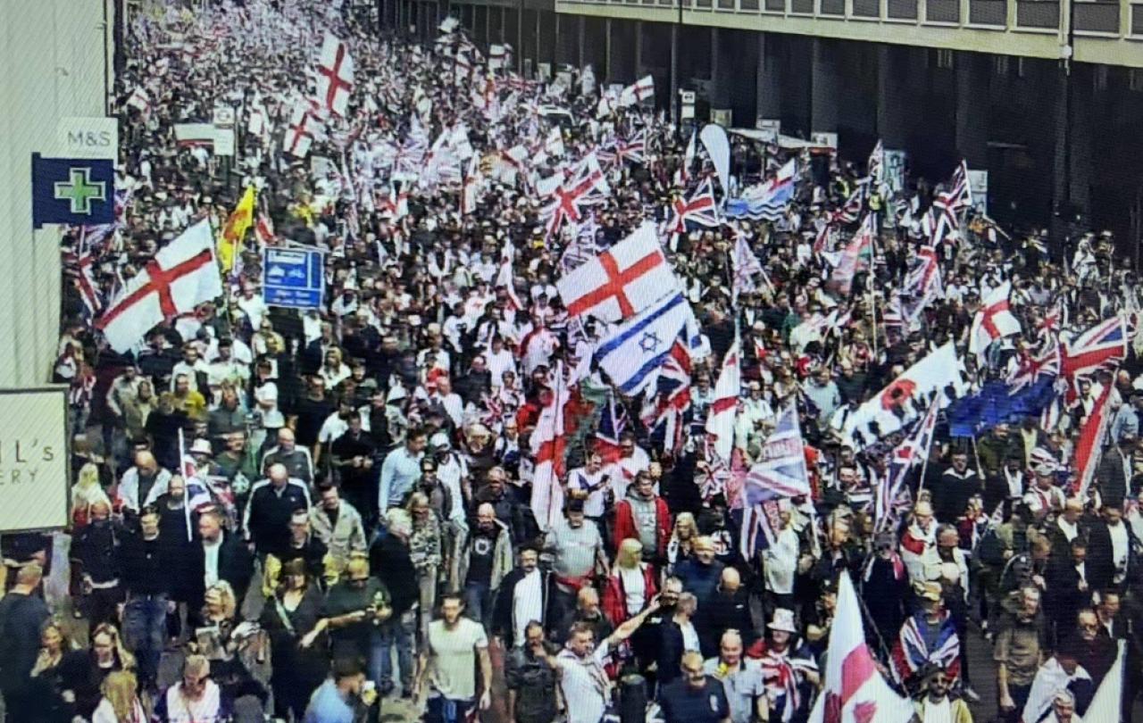 Marchers carry British, English and Israeli flags