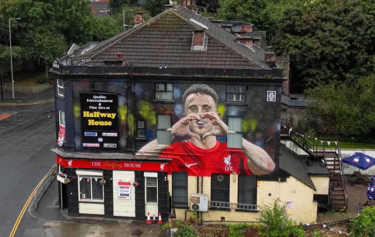 An aerial view of a pub with a large mural of a footballer on it