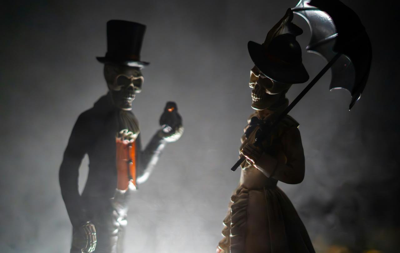 Skeleton figurines clothed in Victoria outfits.