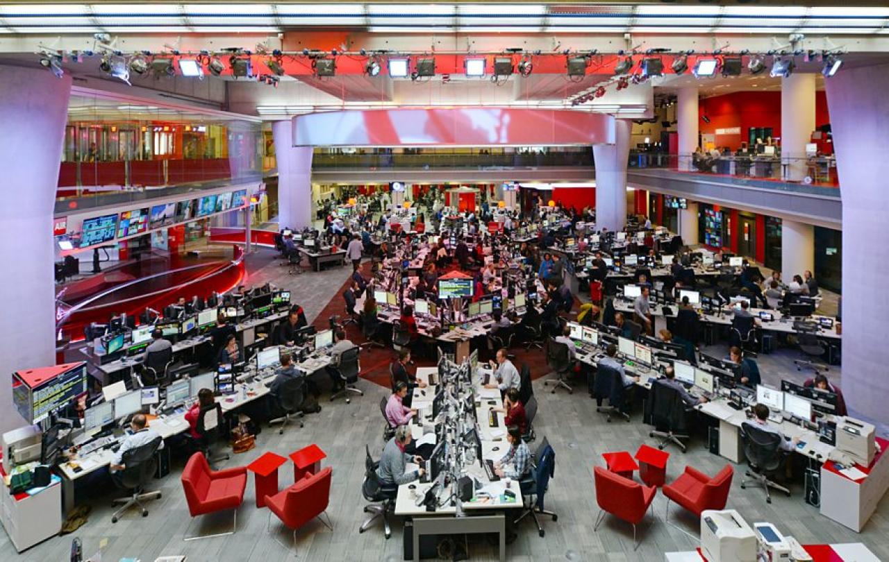 A wide angle view of the BBC newsrooms show a starm layout of desks