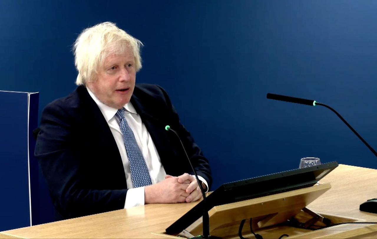 Boris Johnson sits, giving evidence to an inquiry.
