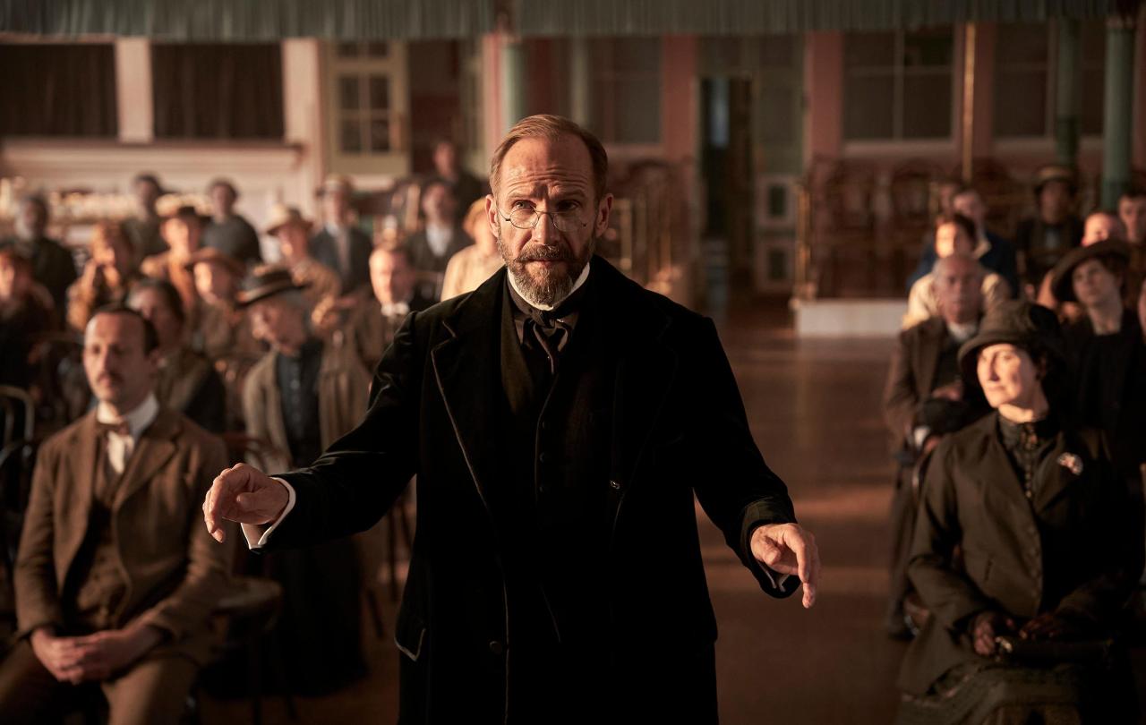 An Edwardian choirmaster conducts.