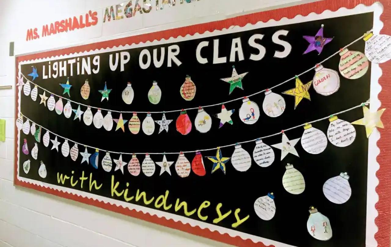 A classroom display of Christmas baubles under a banner.