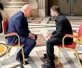 Trump and Zelensky sit and face each other.