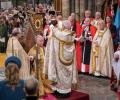 An archbishop raises a crown about the head of King Charles.
