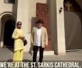 A couple stand on the steps of a cathedral in Iran.