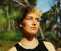 A woman stares away from the camera