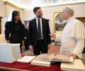 A VIP couple stand and talk with the Pope.