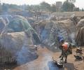 Small huts in a crowded refugee camp.