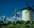 Statues of Don Quixote and Sancho Panza point toward a windmill