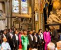 A school choir sings in an ornate abbey setting
