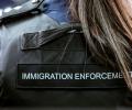 A Border Force officer wears body armour with Immigration Enforcement written on the back