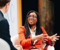 Kemi Badenoch sits and talks.