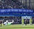A football stand displays a long banner with text on it.