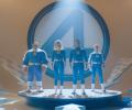 THe Fantastic Four stand on a podium