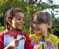 Two Brownies point out their badges.