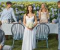 The cast of The Summer I Turned Pretty pose on a wedding set.