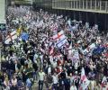 Marchers carry British, English and Israeli flags