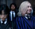 Wednesday Adams scowls while Enid smiles.