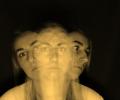 A multiple exposure image shows a womans head and shoulders looking ahead, to the sides and above.