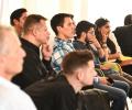 young people listen, and ponder, to a speaker off screen.