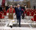 The Pope and King Charles walk together from the Sistine Chapel