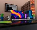 A flat screen on a desk displays a colourful pattern.