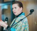 Mette Frederiksen gesture as she delivers a speech. 